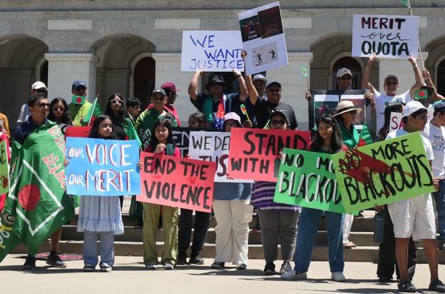 A group of people holding signs Description automatically generated