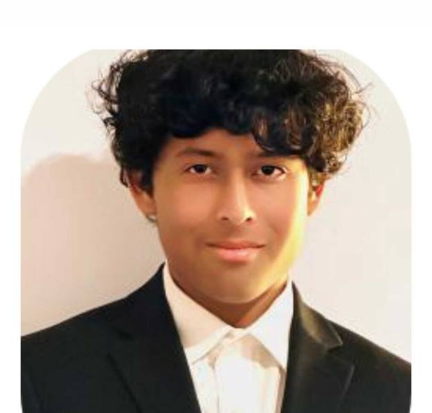 A person in a suit Description automatically generated