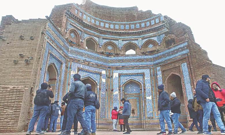 UCH SHARIF: Tourists visit the tomb of Bibi Jawindi in this Punjab town. The monument, dating back to the 15th century, is included in the tentative list of Unesco World Heritage Sites.—APP