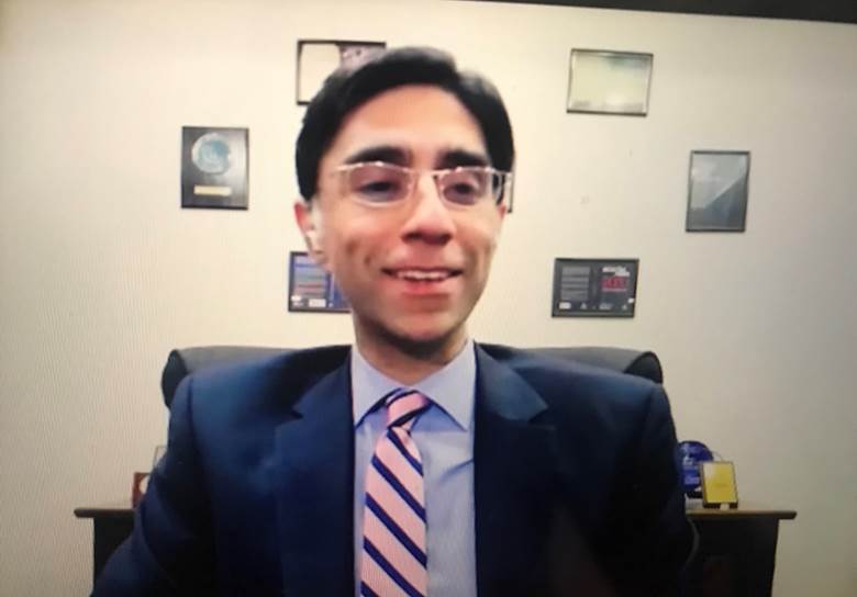 A person in a suit and tie Description automatically generated
