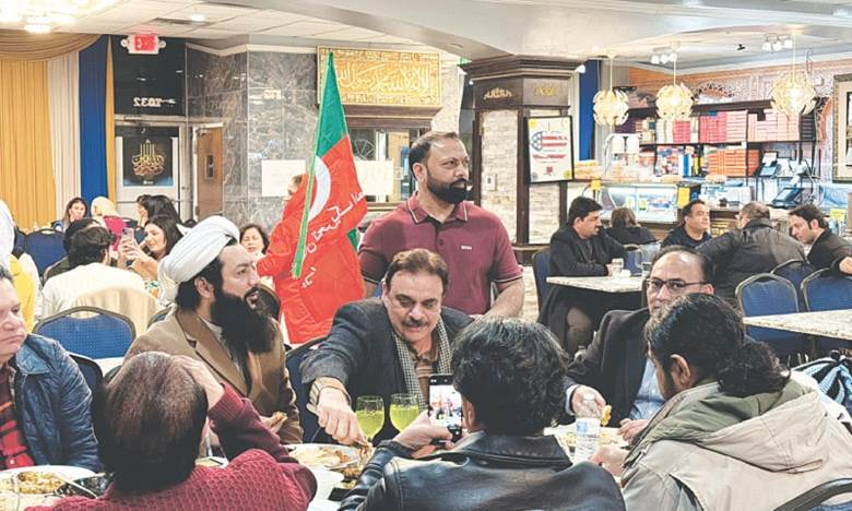 PTI supporters, with their eyes glued to TV screens, dine at a desi restaurant. —Assad Sheikh
