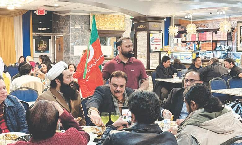 PTI supporters, with their eyes glued to TV screens, dine at a desi restaurant. —Assad Sheikh