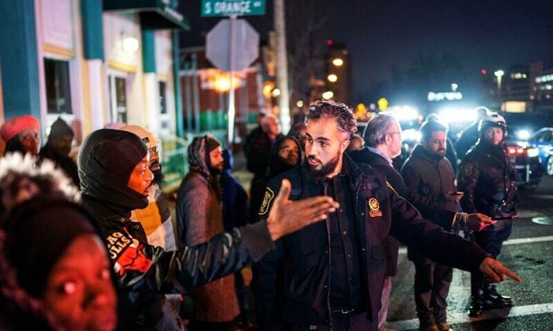 A member of the community talks to the police outside the Masjid Muhammad-Newark mosque following the shooting of Imam Hassan Sharif in Newark, New Jersey, US, January 3, 2024. — Reuters