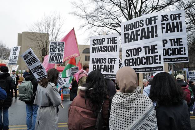 A group of people holding signs Description automatically generated