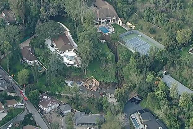 Aerial view of a large house surrounded by trees  Description automatically generated