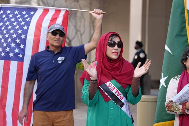 A person and person holding a flag Description automatically generated