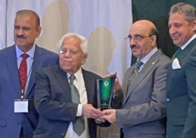 A group of men in suits holding a trophy Description automatically generated