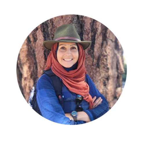 A person wearing a hat and scarf Description automatically generated
