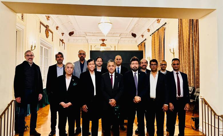 A group of men standing in a room Description automatically generated