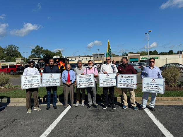A group of people holding signs Description automatically generated