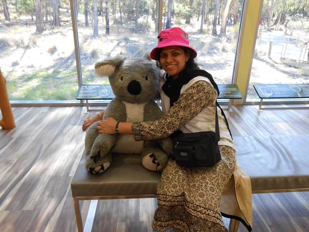 A person holding a stuffed animal Description automatically generated