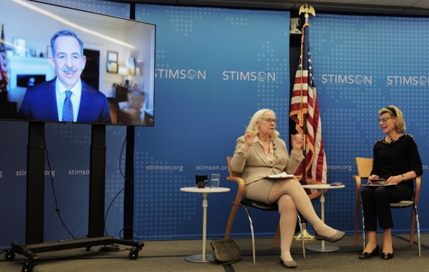 A person sitting in a chair in front of a flag  AI-generated content may be incorrect.