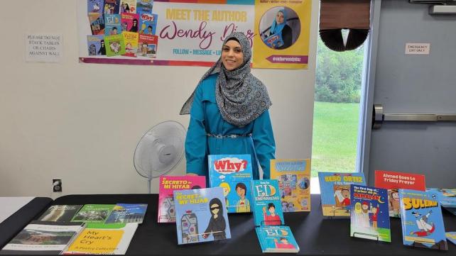 A person standing in front of a table with books AI-generated content may be incorrect.