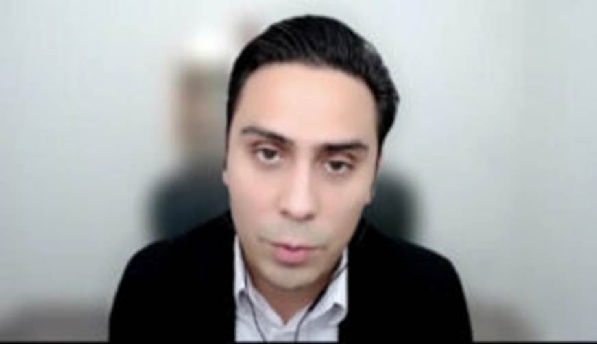 A person looking at the camera Description automatically generated
