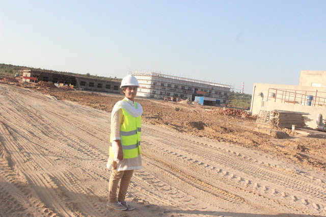 A person wearing a hard hat Description automatically generated with low confidence