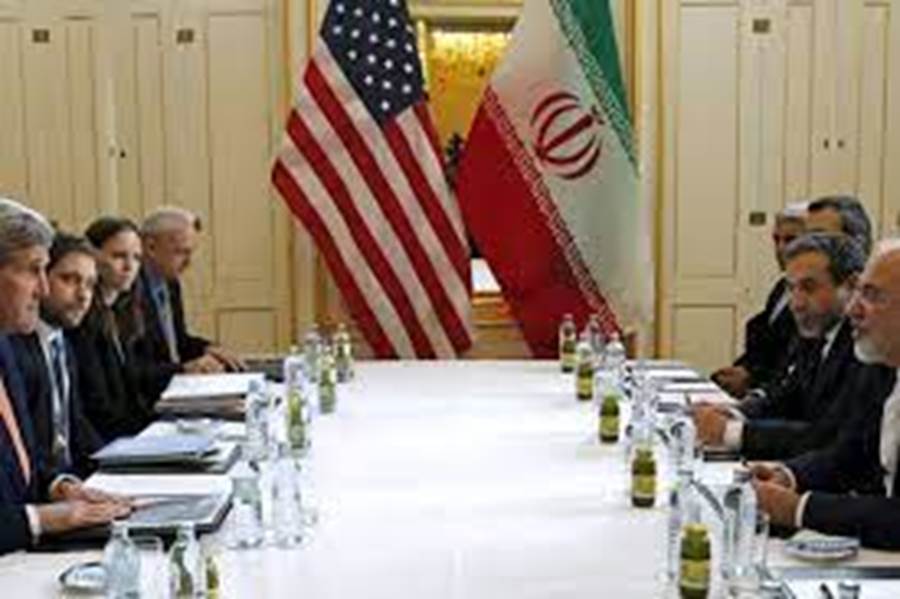 A group of people sitting at a table with drinks and flags Description automatically generated with low confidence