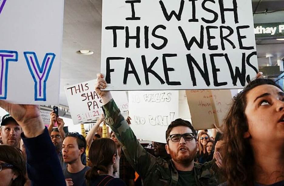 A group of people holding signs Description automatically generated with medium confidence