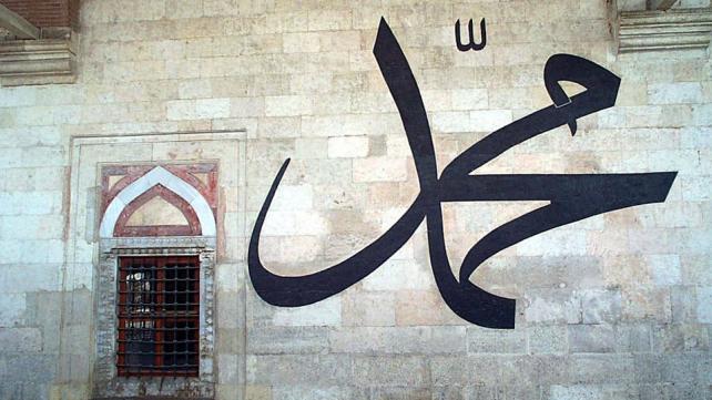 A picture containing text, building, outdoor, graffiti Description automatically generated