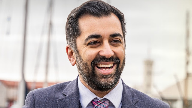 A person smiling for the camera Description automatically generated with medium confidence