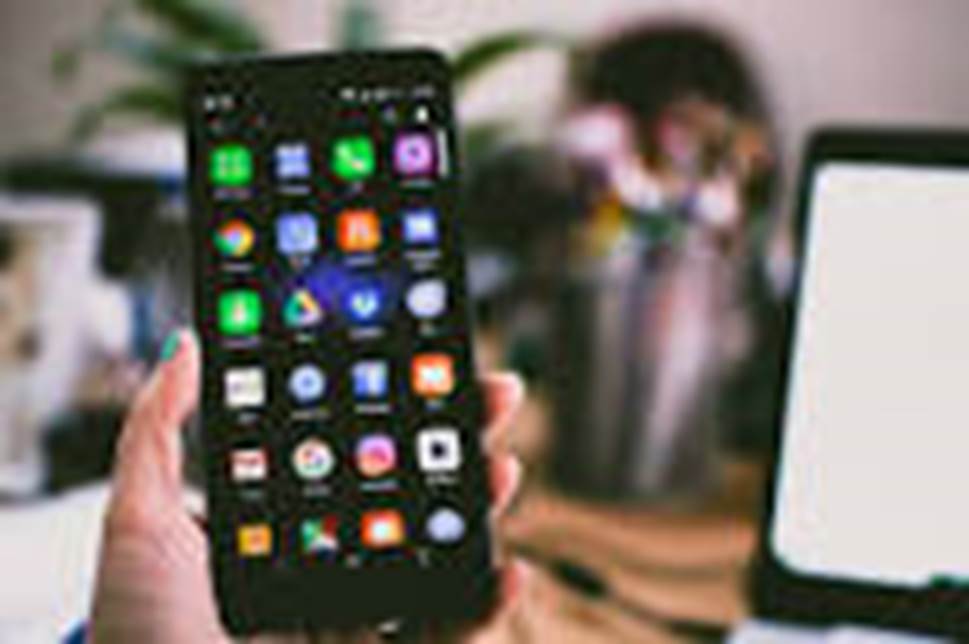 A person holding a cell phone Description automatically generated with medium confidence