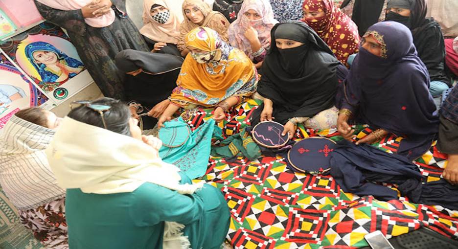 A group of people sitting on the floor Description automatically generated with low confidence