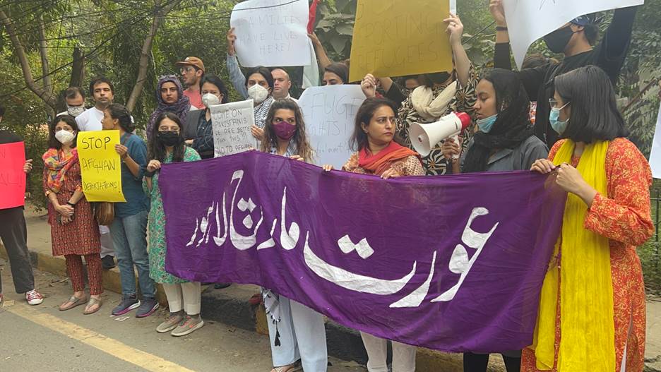 A group of people holding signs Description automatically generated
