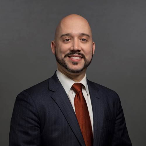 A person in a suit and tie Description automatically generated with medium confidence