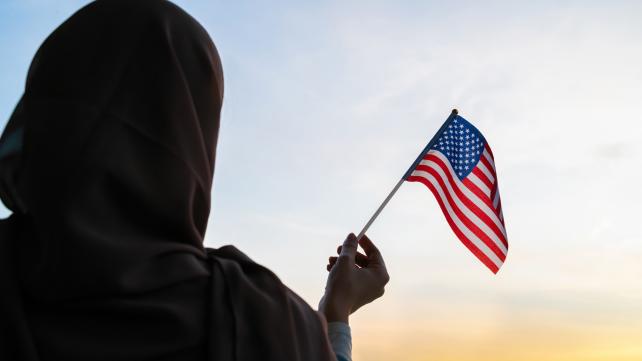A person holding a flag Description automatically generated with medium confidence