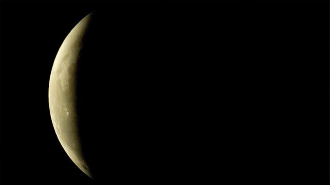 A moon in the sky Description automatically generated