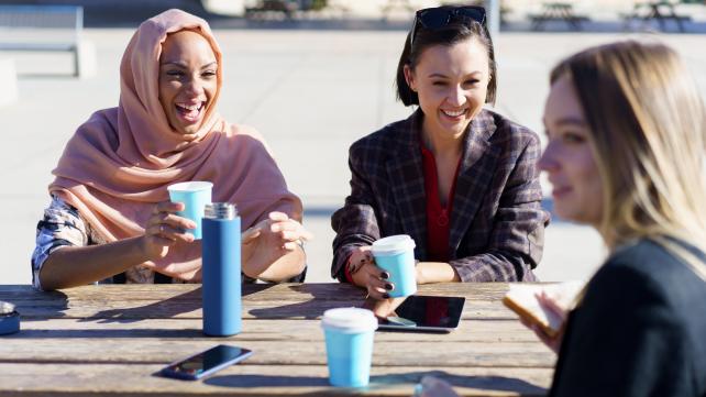 A group of people sitting at a table  Description automatically generated with medium confidence