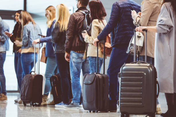 Group of people standing in queue at boarding gate Shot of queue of passengers waiting at boarding gate at airport. Group of people standing in queue to board airplane. airplane passenger stock pictures, royalty-free photos & images