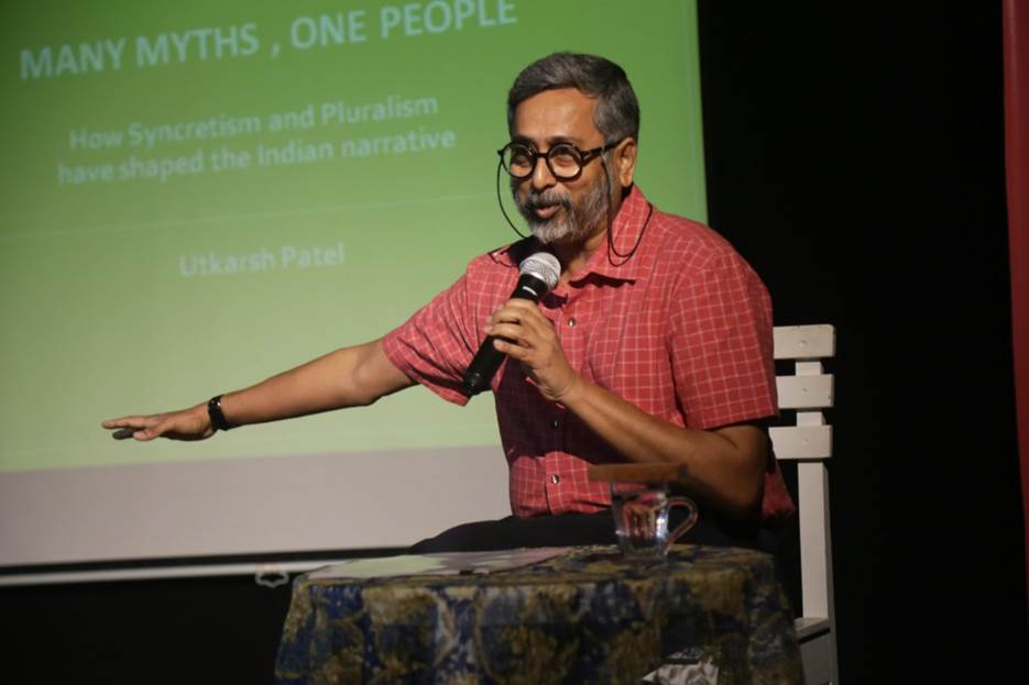 A person speaking into a microphone Description automatically generated with medium confidence