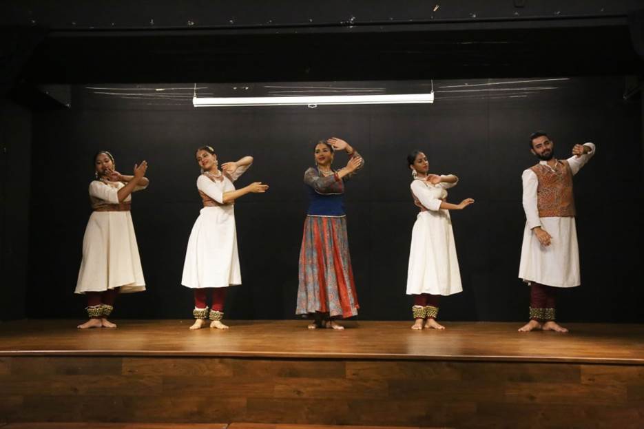 A group of women performing on stage  Description automatically generated with low confidence