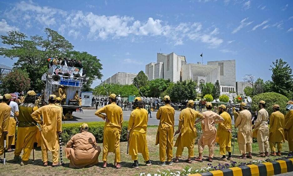 Supporters of parties from Pakistan’s ruling alliance gather near the Supreme Court in Islamabad today to protest against the judiciary’s alleged undue facilitation of PTI chief Imran Khan. — AFP