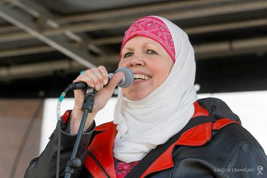 A person singing into a microphone Description automatically generated with medium confidence