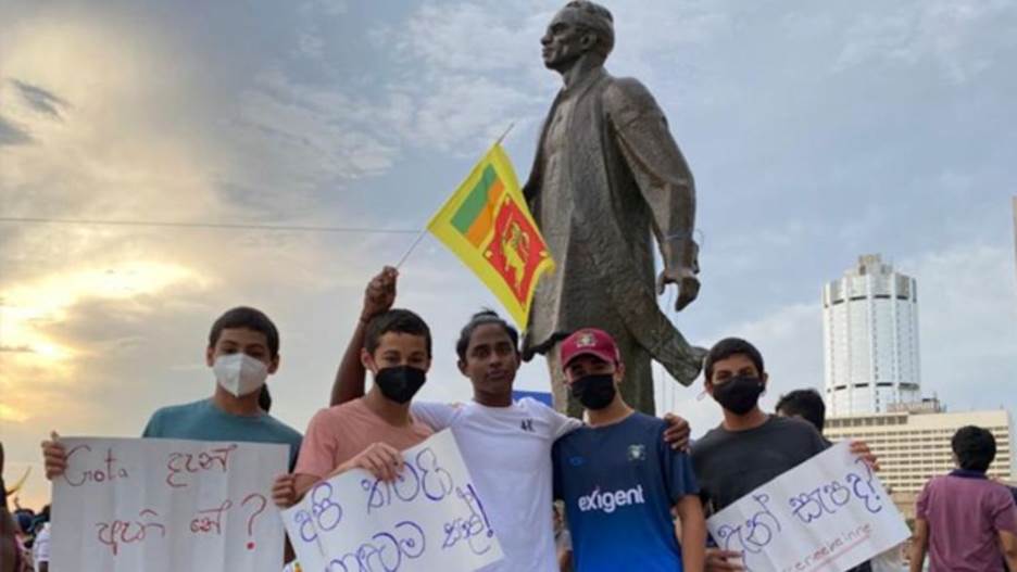 A group of people holding signs and holding flags  Description automatically generated