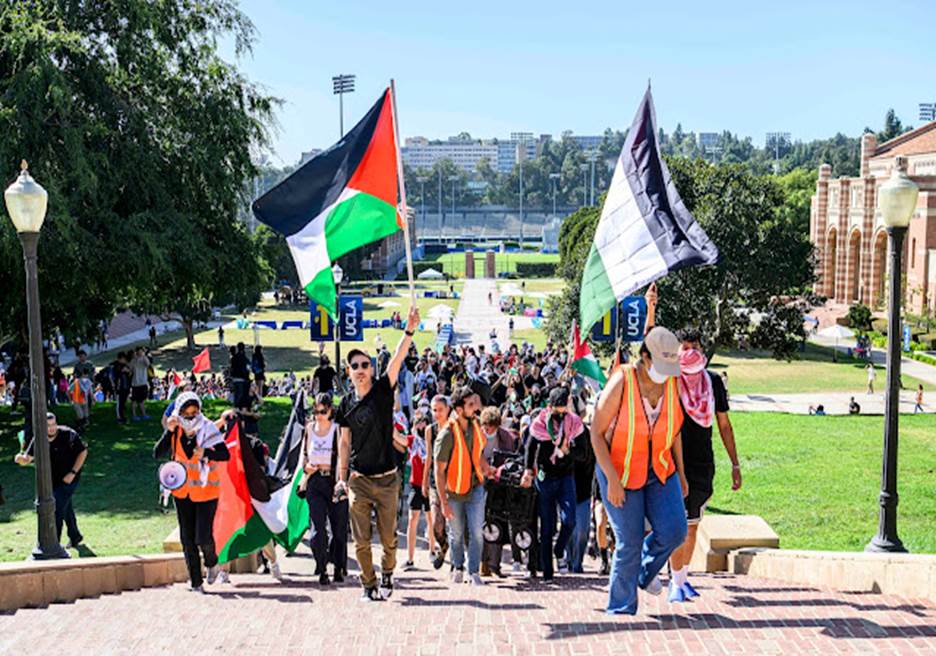 A group of people walking down a path with flags  Description automatically generated