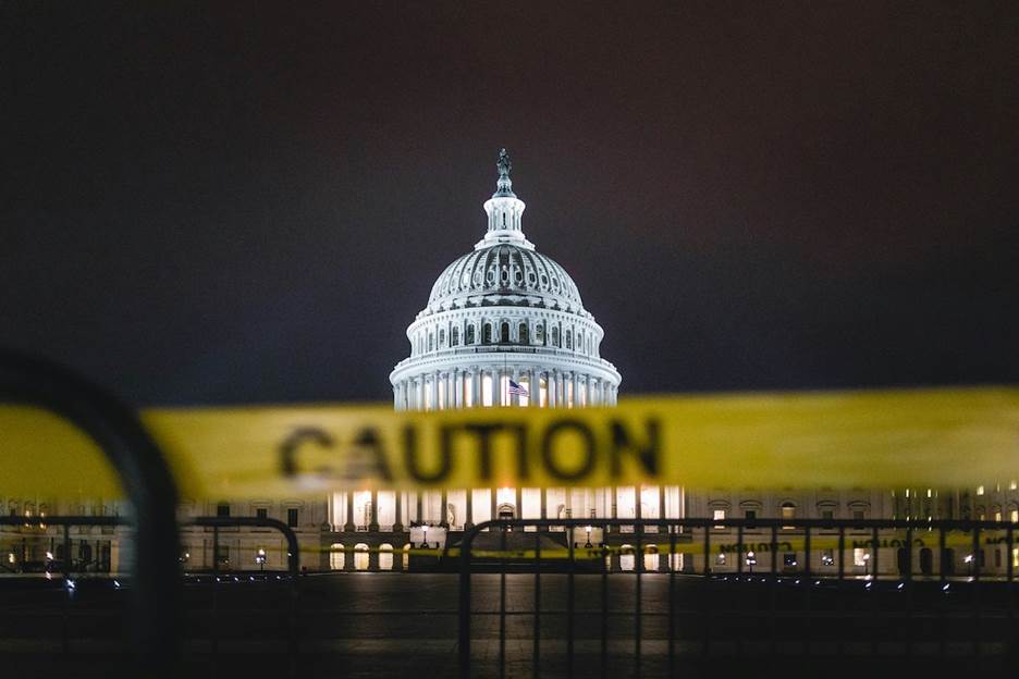 A caution tape in front of a building  Description automatically generated