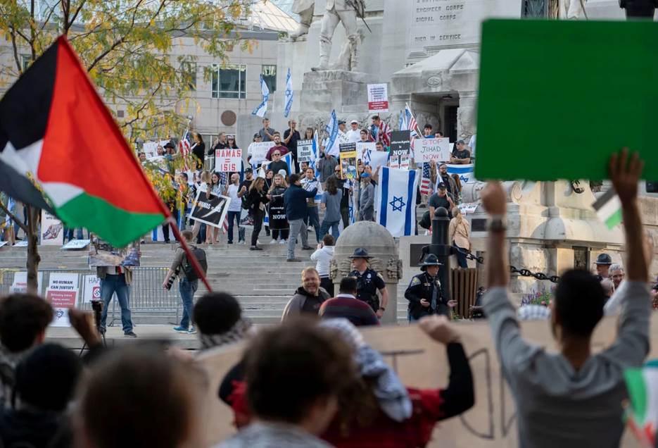 Dozens of pro-Israel counter-demonstrators stand on the steps of the Soldiers & Sailors Monument during a pro-Palestinian rally held Thursday on Monument Circle in Indianapolis.