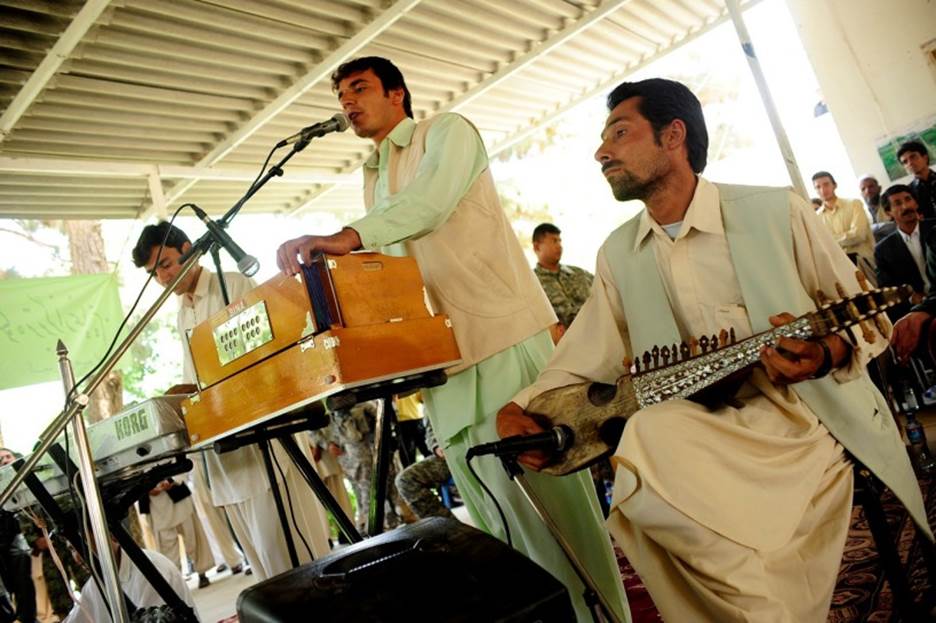 A group of men playing instruments  Description automatically generated