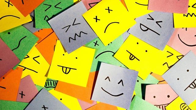 A group of post it notes with drawn faces Description automatically generated with low confidence