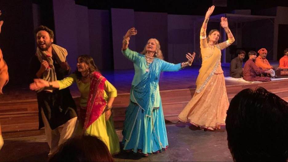 A group of women dancing on a stage Description automatically generated