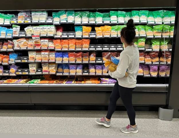 File - A shopper peruses cheese offerings at a Target store on Oct. 4, 2023, in Sheridan, Colo. (AP Photo/David Zalubowski, File)