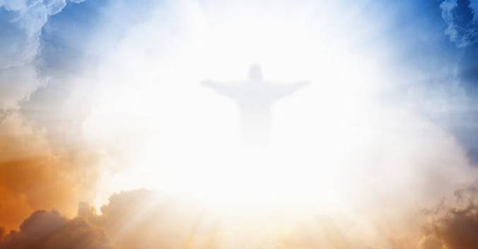A person with arms outstretched in the air Description automatically generated