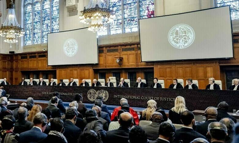 A group of people in a courtroom Description automatically generated