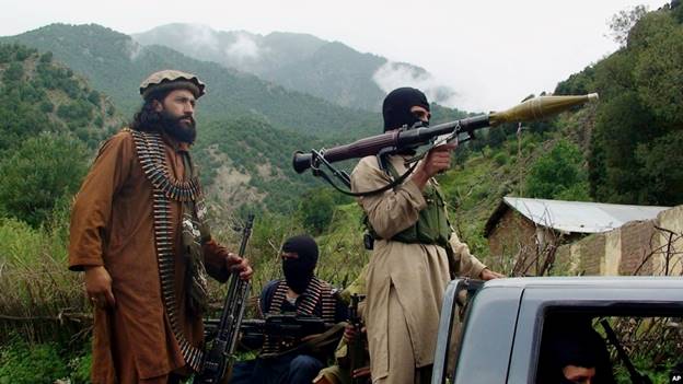 FILE - Pakistani Taliban patrol in then their stronghold of Shawal in Pakistani tribal region of South Waziristan, Aug. 5, 2012. The Pakistani Taliban, known as the TTP, have become emboldened in tribal areas along the border with Afghanistan. 