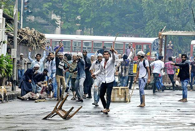 People react during a clash with police at a protest that turned violent in Mumbai. — Reuters