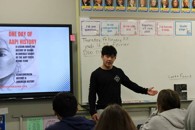 A person standing in front of a whiteboard  Description automatically generated