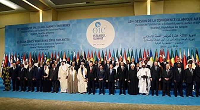 A group of people standing in front of a banner  Description automatically generated