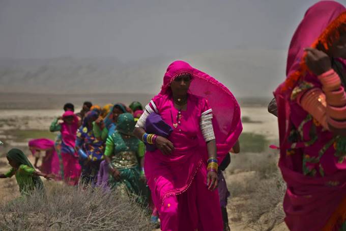 Hindu devotees walk toward a mud volcano to start Hindu pilgrims' religious rituals for an annual festival in an ancient cave temple of Hinglaj Mata in Hinglaj in Lasbela district in the Pakistan's southwestern Baluchistan province, Friday, April 26, 2024. More than 100,000 Hindus are expected to climb mud volcanoes and steep rocks in southwestern Pakistan as part of a three-day pilgrimage to one of the faith's holiest sites. (AP Photo/Junaid Ahmed)